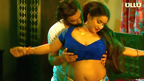 Brunette in a black dress and stockings in the kitchen