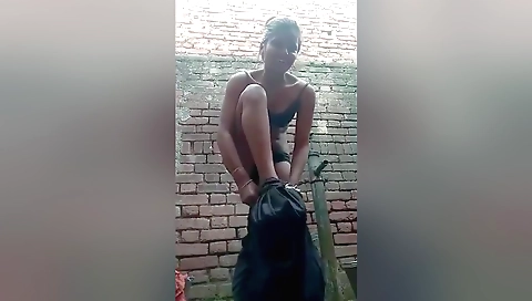 Female in grey suit and black stockings takes bath