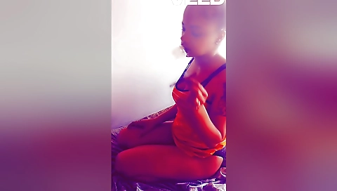 Busty brunette in indian lingerie smoking in front of a camera