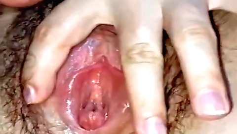 Amateur solo female with a hairy pussy shows it to the camera