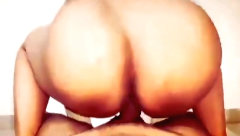 Indian girl in red dress and white blouse is cooking